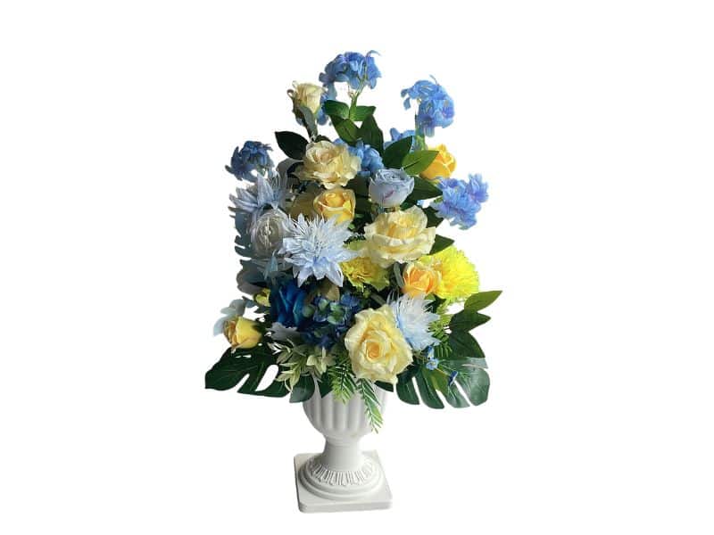 Artificial Flowers in White Urn Blue and yellow available for hire Auckland wide